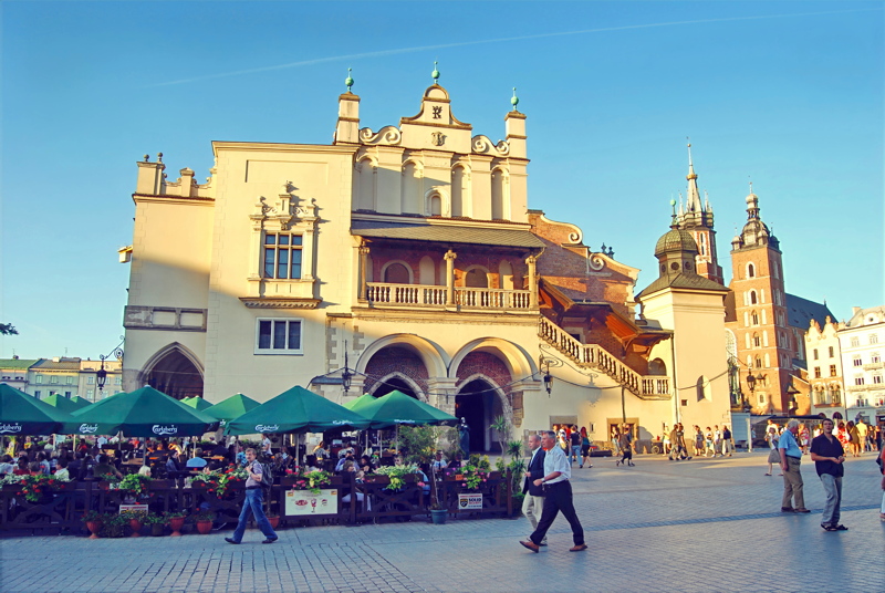 The historic Sukiennice (Cloth Hall) situated in the center of the Main Market Square in Kraków, Poland, featuring its 16th-century Renaissance loggia and outdoor café seating